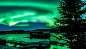 A night sky with dancing green northern light.