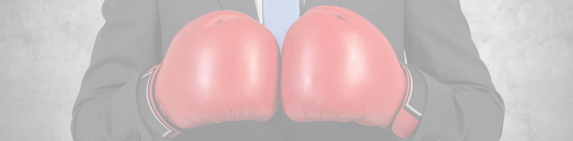 Man in suit wearing boxing gloves