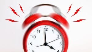 red alarm clock ringing with red noise marks