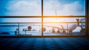 a plane through a window in an airport