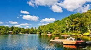 Cottage shoreline with boats and a floating dock